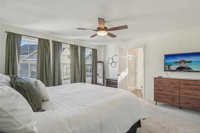 carpeted bedroom featuring connected bathroom and ceiling fan