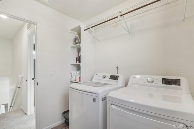 washroom featuring washing machine and dryer and carpet