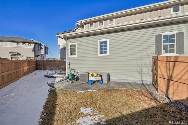 rear view of property featuring a patio and central air condition unit