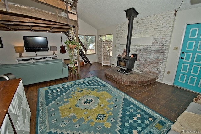 living room with a textured ceiling and a wood stove