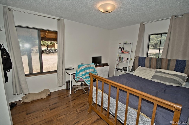 bedroom with hardwood / wood-style flooring and a textured ceiling