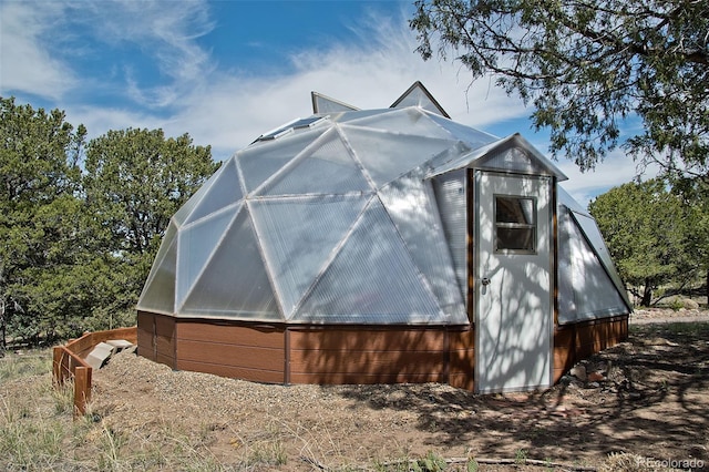 view of home's exterior with an outbuilding