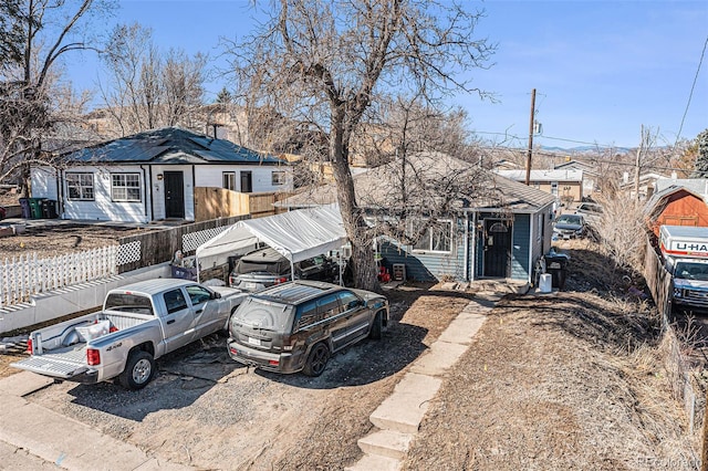 view of front facade with a residential view and fence