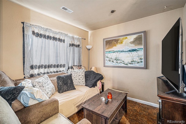 living room featuring baseboards and visible vents