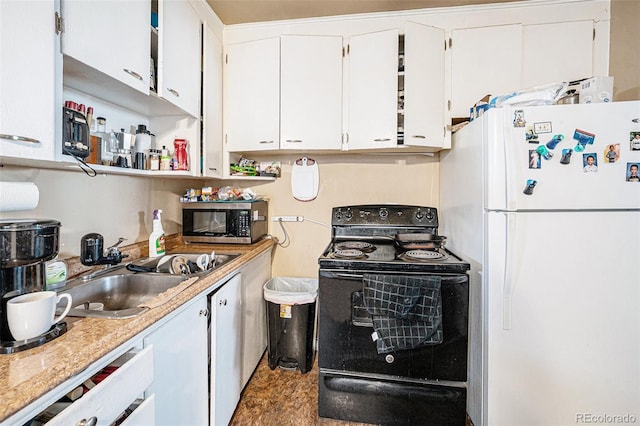 kitchen with light countertops, stainless steel microwave, freestanding refrigerator, a sink, and black range with electric cooktop