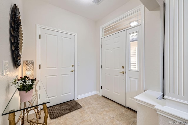 entryway featuring baseboards and light tile patterned flooring