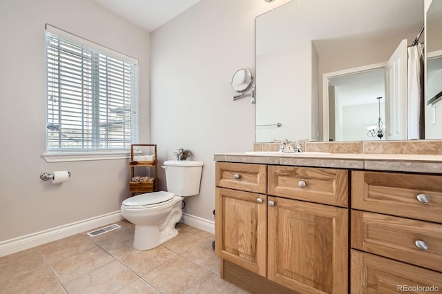 bathroom featuring toilet, vanity, baseboards, tile patterned flooring, and visible vents