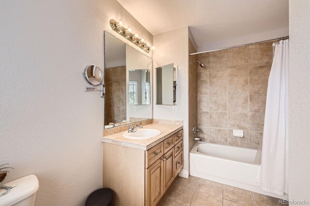 bathroom with vanity, tile patterned flooring, shower / bathtub combination with curtain, and toilet