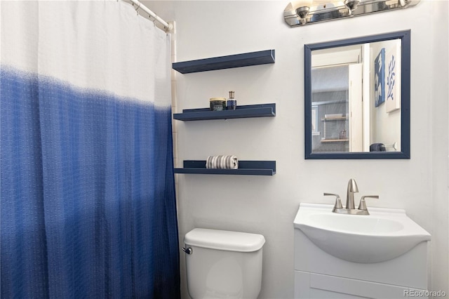 bathroom featuring vanity and toilet