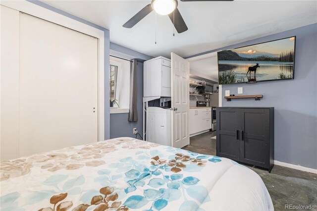 bedroom with concrete floors, a ceiling fan, and baseboards