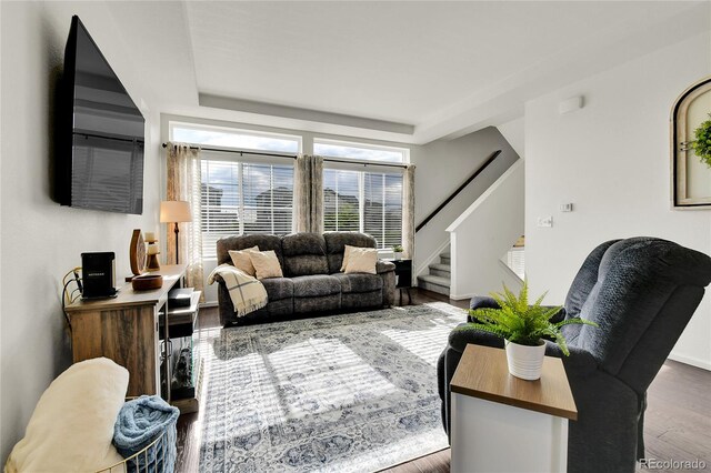 240 S Oak Hill St, Aurora, CO 80018 - living room featuring stairway, wood finished floors, a raised ceiling, and baseboards