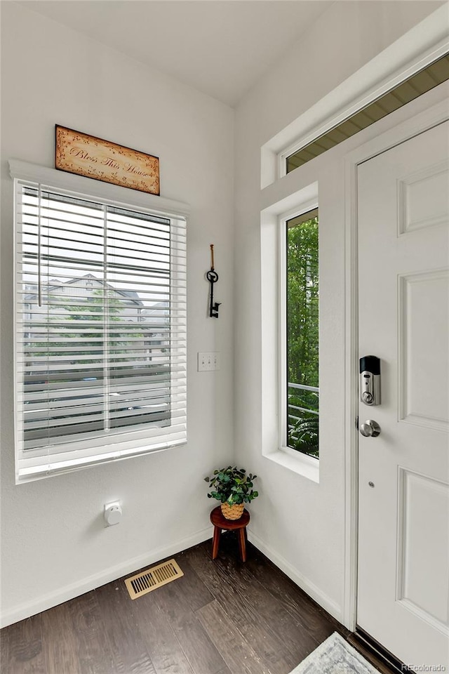 240 S Oak Hill St, Aurora, CO 80018 - doorway to outside featuring baseboards and dark wood-style floors