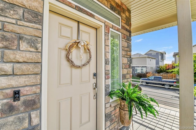 240 S Oak Hill St, Aurora, CO 80018 - view of exterior entry with a porch and stone siding