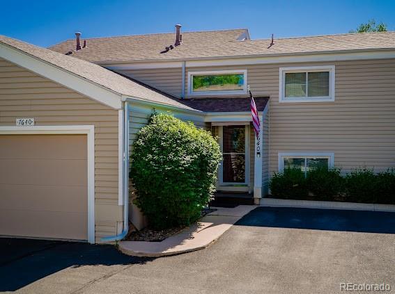 7640 S Monaco Cir W, Centennial, CO 80112 - doorway to property with driveway and an attached garage