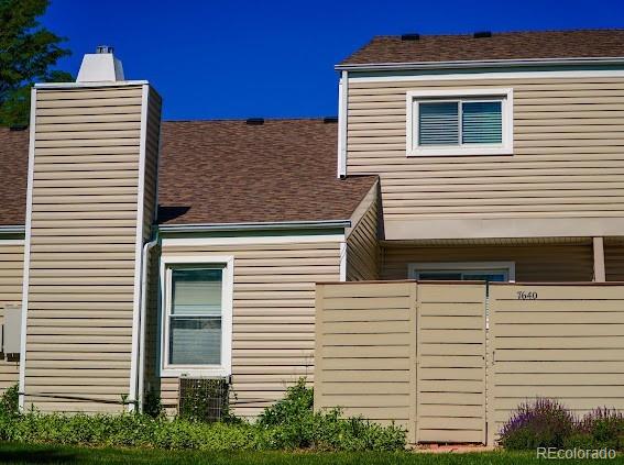 7640 S Monaco Cir W, Centennial, CO 80112 - view of side of property featuring a chimney and a shingled roof
