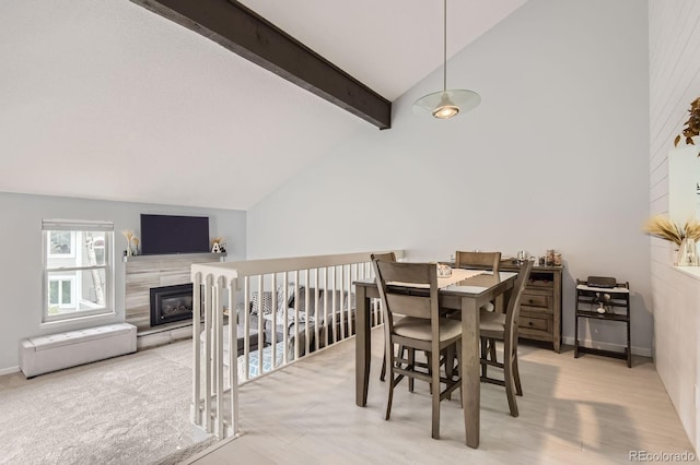 7640 S Monaco Cir W, Centennial, CO 80112 - dining area featuring high vaulted ceiling, beam ceiling, and a fireplace