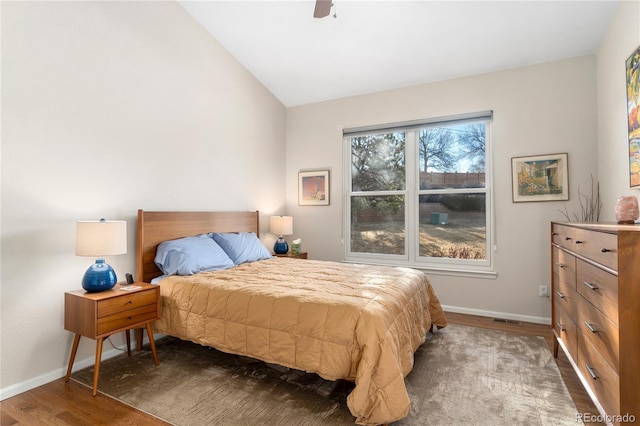 bedroom with lofted ceiling, wood finished floors, a ceiling fan, and baseboards