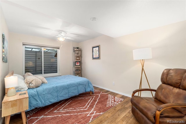 bedroom featuring baseboards and wood finished floors