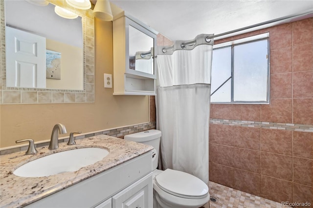 bathroom with toilet, vanity, and a shower with shower curtain