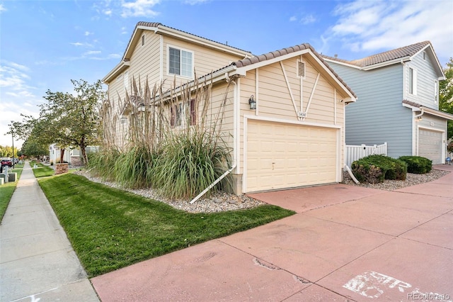 view of home's exterior with a garage and a yard