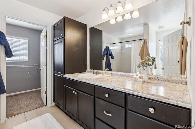 bathroom featuring tile patterned flooring, vanity, and a shower with shower curtain