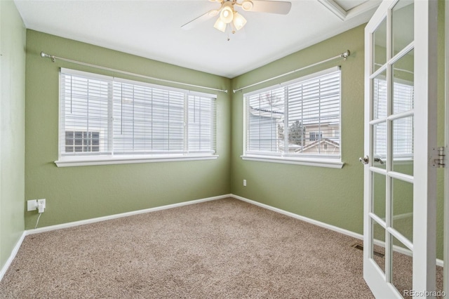 carpeted spare room with ceiling fan