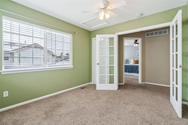 unfurnished room with carpet floors, ceiling fan, and french doors