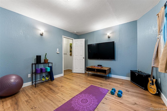 workout area with hardwood / wood-style flooring