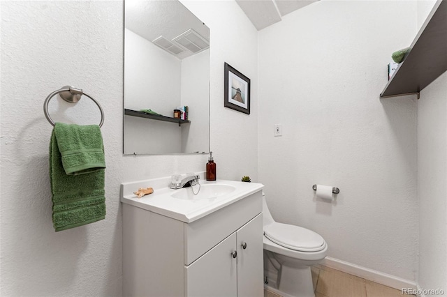 bathroom featuring vanity, tile patterned flooring, and toilet