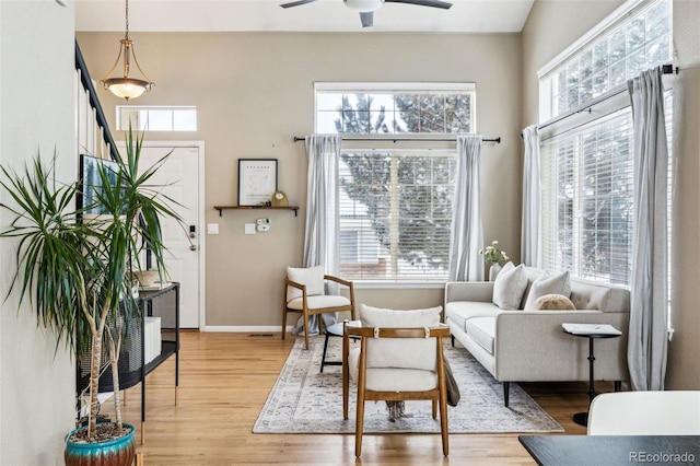 sitting room with light hardwood / wood-style flooring and ceiling fan