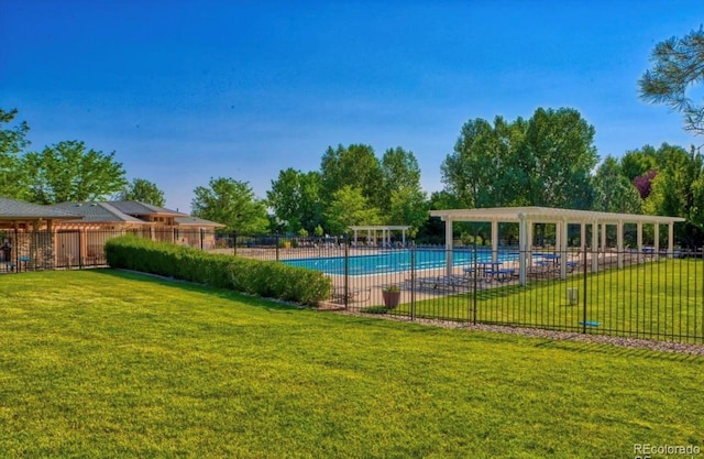 view of swimming pool with a pergola and a yard