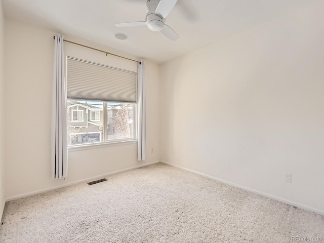 carpeted spare room with ceiling fan