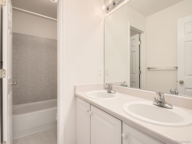 bathroom featuring vanity, tile patterned flooring, and tiled shower / bath