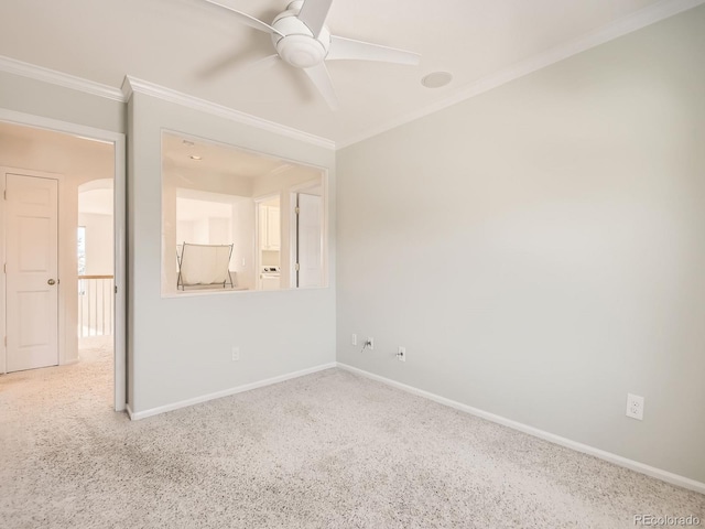 carpeted spare room featuring ceiling fan and crown molding