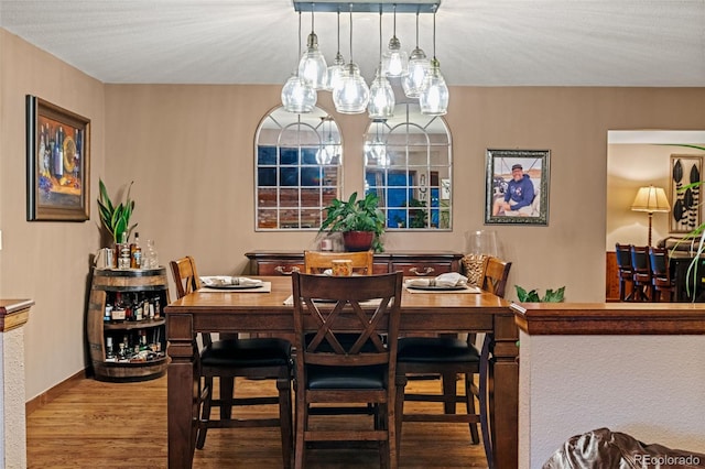 dining room featuring baseboards and wood finished floors