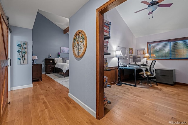 office with baseboards, wood finished floors, a ceiling fan, and vaulted ceiling