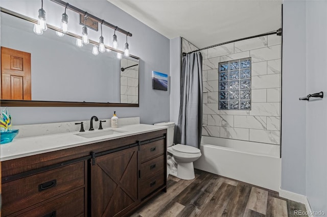 full bathroom with toilet, shower / bath combo with shower curtain, vanity, and wood finished floors