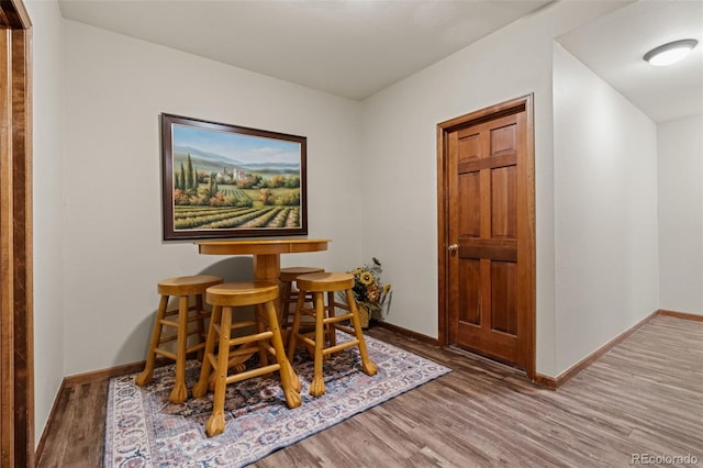 dining room featuring baseboards and wood finished floors