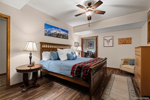 bedroom with a ceiling fan, baseboards, and dark wood-style flooring