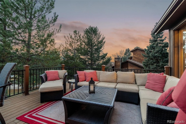 deck at dusk with an outdoor hangout area