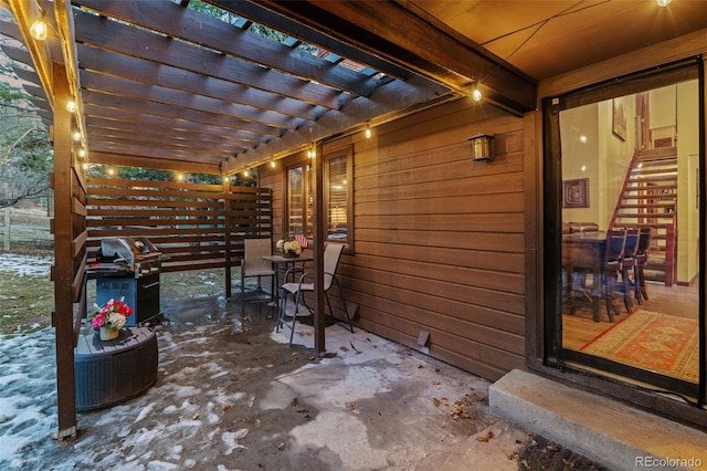 view of patio with area for grilling and a pergola