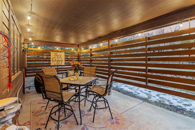 interior space featuring rail lighting and concrete floors