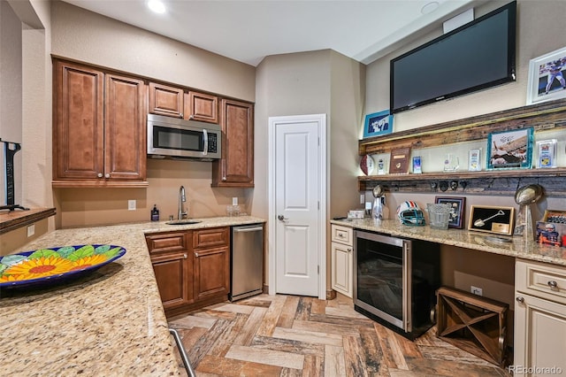 12121 Bryant St, Westminster, CO 80234 - kitchen with stainless steel microwave, wine cooler, light stone countertops, recessed lighting, and brown cabinetry