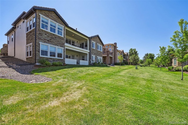 12121 Bryant St, Westminster, CO 80234 - back of house featuring stone siding and a lawn