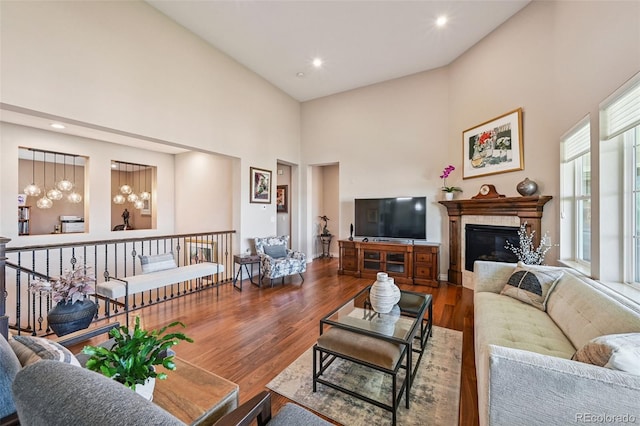 12121 Bryant St, Westminster, CO 80234 - living area featuring a high ceiling, wood finished floors, a glass covered fireplace, and recessed lighting