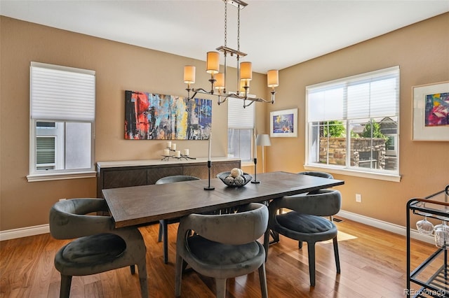 12121 Bryant St, Westminster, CO 80234 - dining room featuring a chandelier and wood finished floors