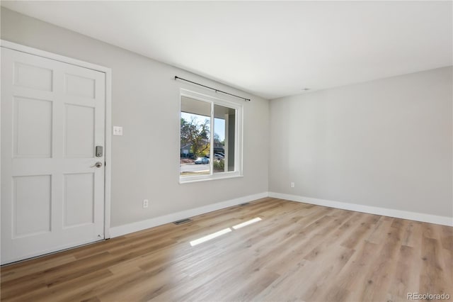 empty room with light hardwood / wood-style floors