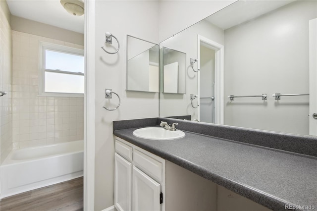 bathroom featuring a bath, vanity, and hardwood / wood-style flooring