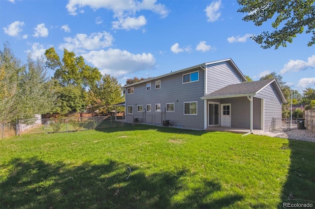 rear view of property featuring a patio area and a yard