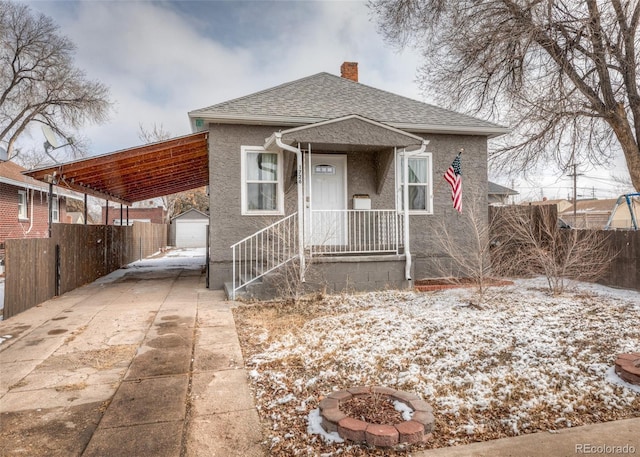 1726 E Evans Ave, Pueblo, CO 81004 - bungalow with an outdoor structure, concrete driveway, a chimney, a shingled roof, and an attached carport